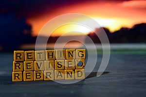 Rethink - Revise - Rebrand on wooden blocks. Cross processed image with bokeh background photo