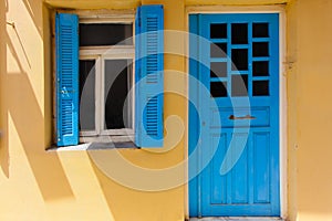 Rethymno, Island Crete, Greece, - June 23, 2016: Traditional Greek house with window with blue shutters and wood door