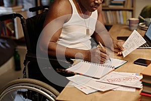 Retired African American Man with Disability Working with Bills at Home