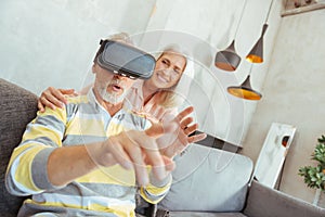 Retired aged man trying up VR glasses