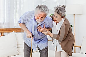 Retired Asian senior elderly husband pain from heart attack disease or illness with serious or worried wife take care at home.