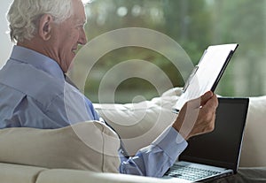 Retired businessman analyzing business columns