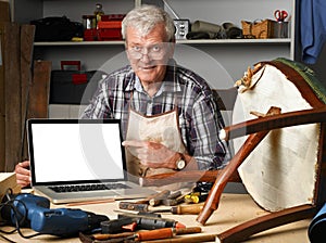 Retired carpenter with laptop