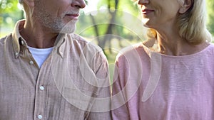 Retired couple looking each other, romantic date outdoor, relation closeness