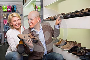 Retired couple shopping mans shoes