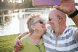 Retired couple taking a selfie in a park