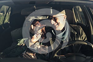 Retired couple on vacation consults directions on smart phone gps - active seniors traveling enjoy free time and retirement -