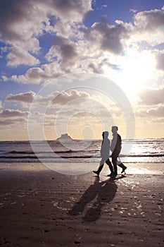 Retired Couple Walking on the Beach