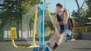 A retired elderly man works out on a sports ground outside. Healthy lifestyle concept.