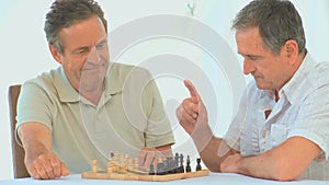 Retired friends playing chess