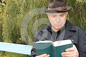 Retired gentleman reading a book