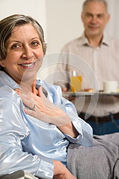 Retired husband bringing breakfast to bed