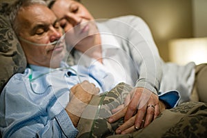 Retired ill man and caring wife sleeping