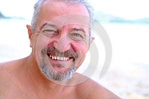 Retired joyful man relaxing on the beach