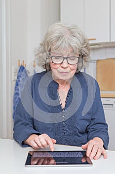 Retired lady with tablet-pc