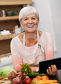 Retired lady, tablet and vegetables for cooking wholesome, healthy and nutritional food at home. Senior woman