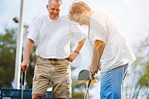 Retired lifestyle of senior couple playing mini golf