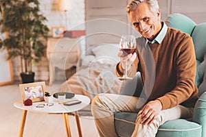 Retired man drinking wine celebrating his birthday