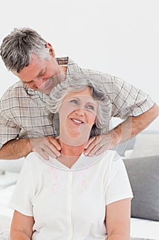 Retired man giving a massage to his wife