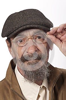 Retired man with glasses and newsboy hat photo