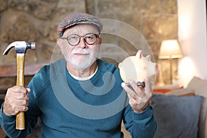 Retired man holding benefits in piggy bank