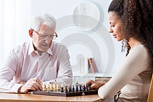 Retired man playing chess