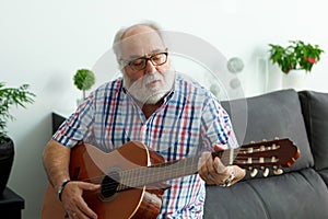 Retired man playing guitar