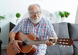 Retired man playing guitar