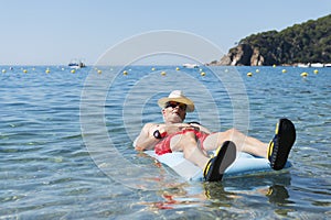 Retired man playing in sea water