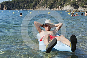 Retired man playing in sea water