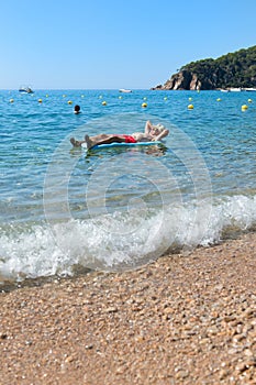 Retired man playing in sea water