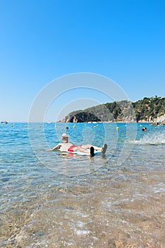 Retired man playing in sea water