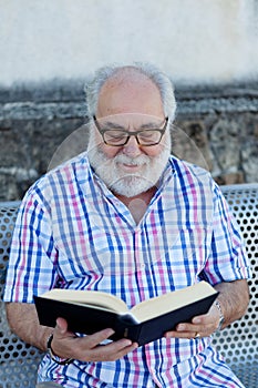 Retired man reading a book