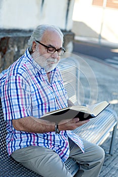 Retired man reading a book