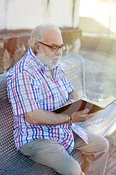 Retired man reading a book