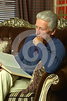 Retired man reading book