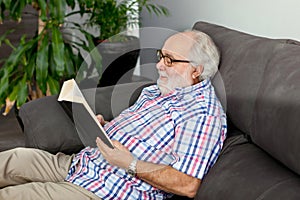 Retired man reading a book