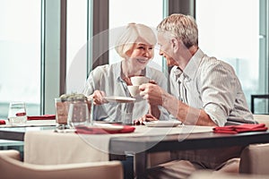 Retired man and woman having morning coffee together