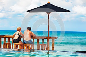 Retired mature couple relaxing beach swimming pool