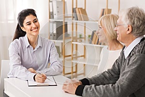 Retired old couple planning investments with financial consultant