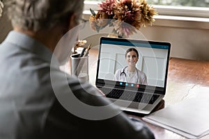 Retired old man holding video call consultation with doctor.