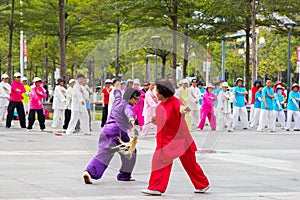 Retired people are practicing martial art dance in street