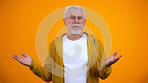 Retired person showing no idea gesture with hands, lack of information, answer