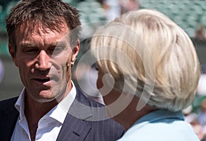 Retired player Pat Cash being interviewed by Sue Barker on centre court before the start of the men`s finals.