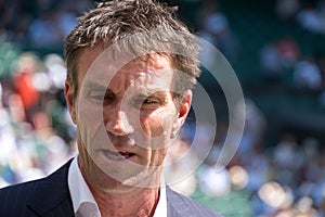 Retired player Pat Cash being interviewed by Sue Barker on centre court before the start of the men`s finals.