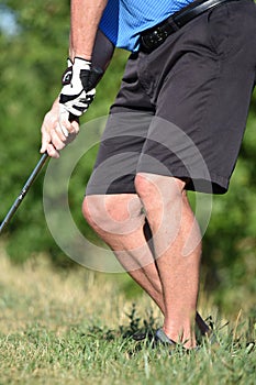 Retired Senior Athletic Man Exercising With Golf Club Swinging