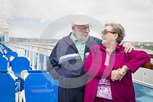 Retired Senior Couple Enjoying The Deck of a Cruise Ship