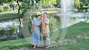 Retired Senior couple vacation holiday together at park.