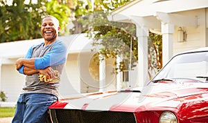 Retired Senior Man Cleaning Restored Car photo