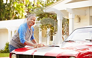 Retired Senior Man Cleaning Restored Car photo